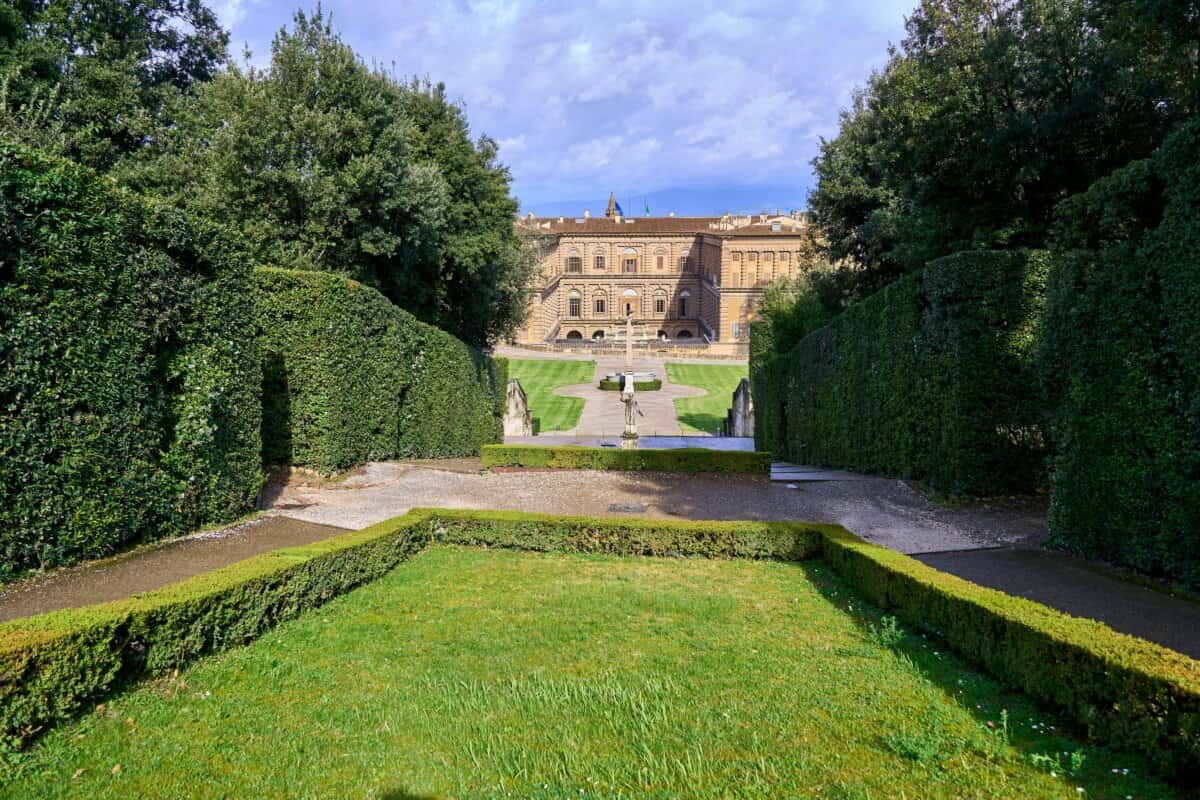 Manicured garden leading to historic stone building